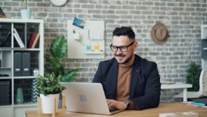 Man looking at laptop smiling