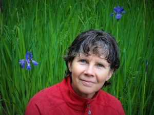 Headshot of Theresa Southam in a field of tall grass