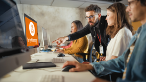 instructors looking at computer screens with the brightspace logo on it
